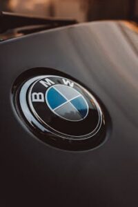 Close-up of a shiny BMW logo on a luxury car, emphasizing modern design.